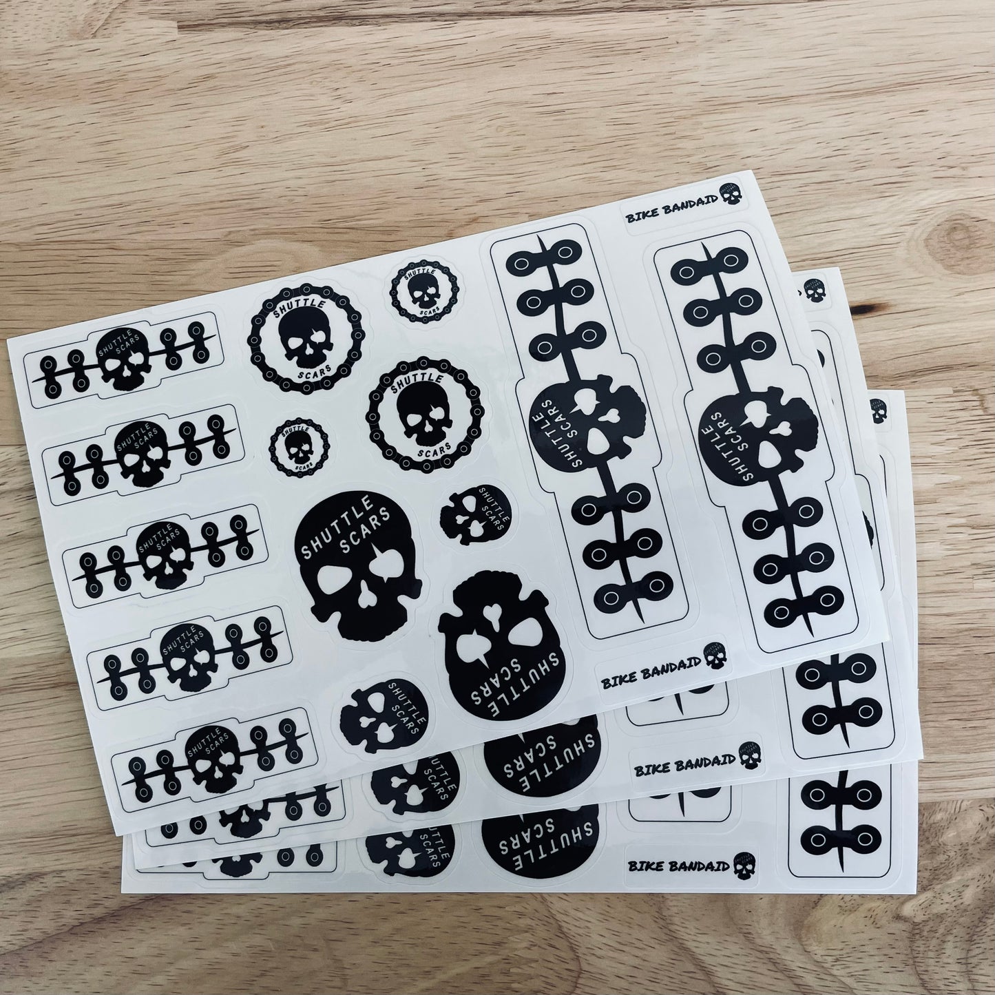 Shuttle Scars Bike Bandaids Protective Vinyl Stickers (Clear with Black Graphics), 3-Pack (3 Sheets of 15 each)